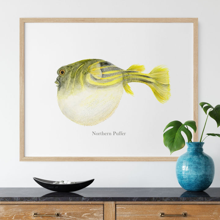 a painting of a yellow northern puffer on a white wall