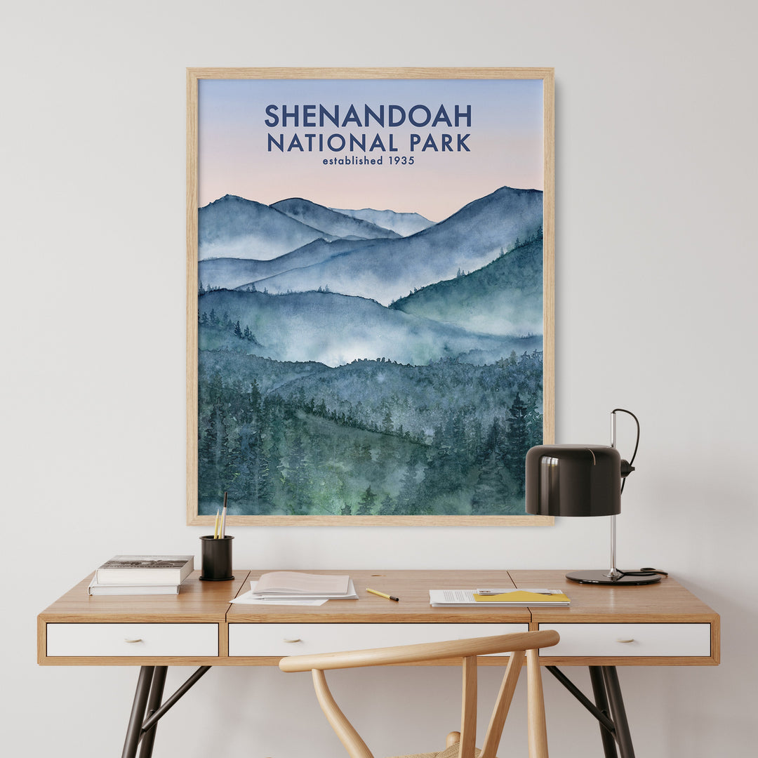 a desk with a poster of a mountain range