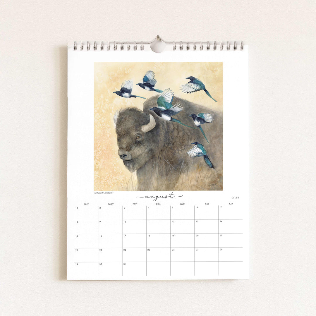 Watercolor painting of a bison with magpies titled "In Good Company," featured in the 2027 wildlife calendar