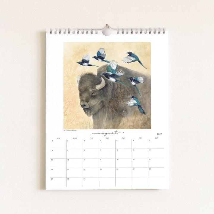 Watercolor painting of a bison with magpies titled "In Good Company," featured in the 2027 wildlife calendar